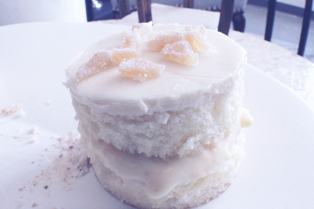A small white cake topped with candied ginger.